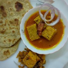 A picture of "Besan dhokli sabji with ghee Paratha and caramelized dhokli".