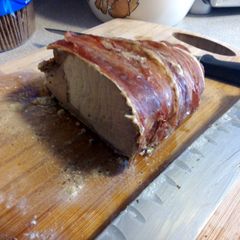 A picture of prosciutto wrapped pork loin w/ herb cheese.