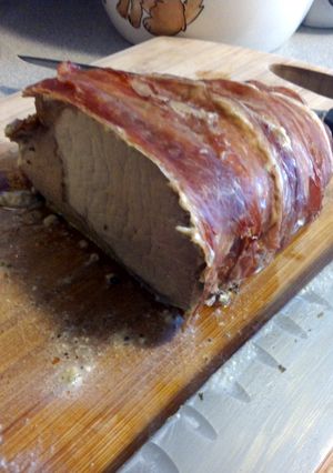 A picture of prosciutto wrapped pork loin w/ herb cheese.