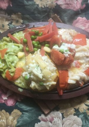 A picture of Italian sizzler with spinach, pineapple pasta.
