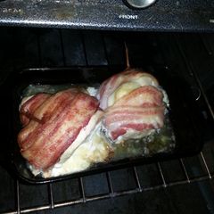 A picture of Bacon wrapped swiss chicken breasts.