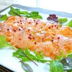 A picture of Salmon Carpaccio with Pink Peppercorns.