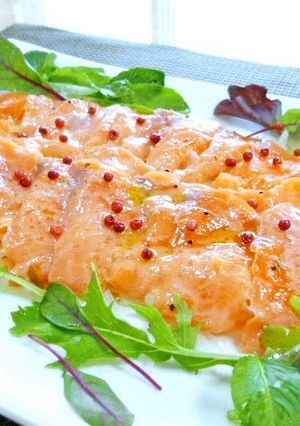 A picture of Salmon Carpaccio with Pink Peppercorns.