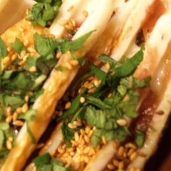 A picture of Umeboshi Filled Chikuwa Topped with Shiso Leaves and Sesame Seeds.