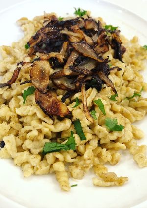 A picture of Spaetzle with Butter, Fried Onion, and Gruyere Cheese.