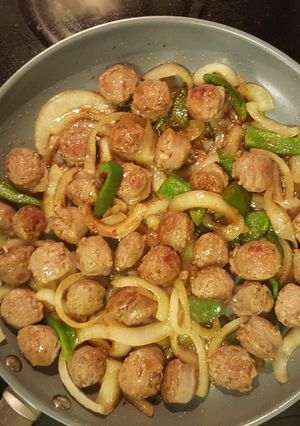 A picture of Italian sausage with pepper/onions.