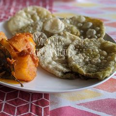A picture of Koraishutir Kochuri (Bengali Peas Puri) with Aloo Dum.