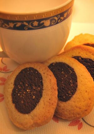 A picture of Black and white tea party cookies.