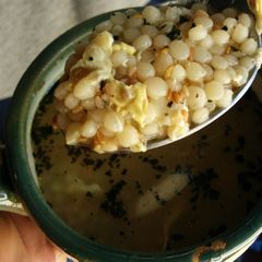 A picture of Basil egg drop couscous soup.