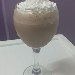 A picture of Chocolate milk shake with whipped cream.
