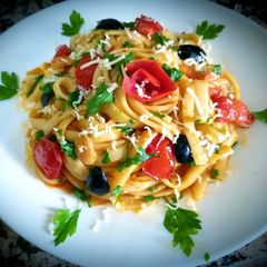 A picture of Tagliatelle with tomato sauce and marinated cherry tomatoes.