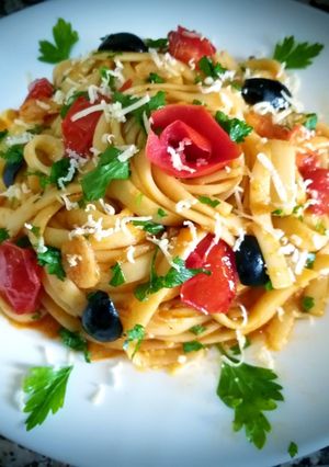 A picture of Tagliatelle with tomato sauce and marinated cherry tomatoes.