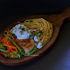 A picture of Grilled Chicken Sizzler With Mushroom Sauce.