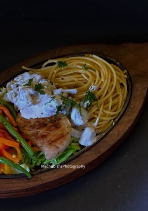 A picture of Grilled Chicken Sizzler With Mushroom Sauce.