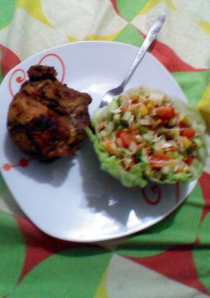 A picture of Roasted chicken and salad.