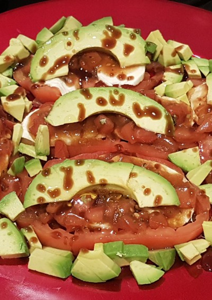 Una foto de Tomate, mozzarella y aguacate marinados con vinagreta de tomate