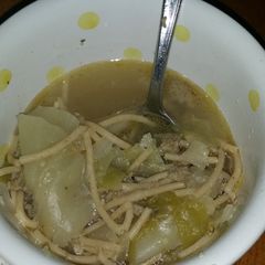 A picture of Sausage and cabbage noodle soup.