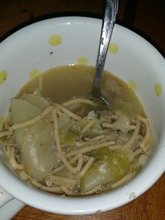 A picture of Sausage and cabbage noodle soup.