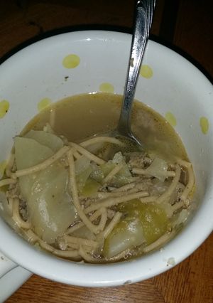 A picture of Sausage and cabbage noodle soup.