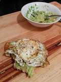 toasted ciabatta slice with mashed avocado spread and fried egg