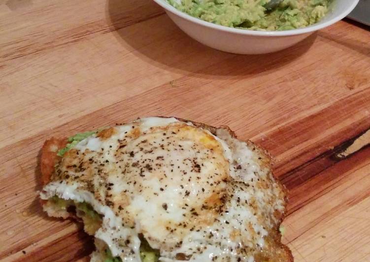 toasted ciabatta slice with mashed avocado spread and fried egg