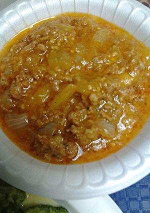 A picture of Creamy coconut curry with sausage and eggplant.