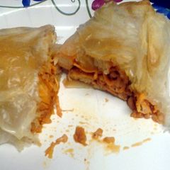 A picture of achiote chicken and rice in a sack.