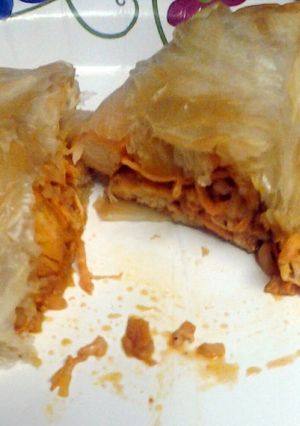 A picture of achiote chicken and rice in a sack.