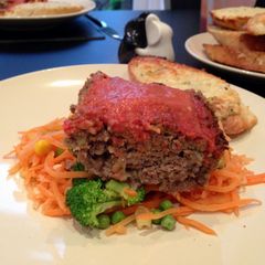 A picture of Meatloaf with tomato and red pepper sauce.