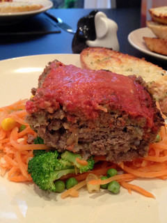 A picture of Meatloaf with tomato and red pepper sauce.