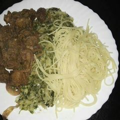 A picture of Spaghetti with fried pork and steamed cabbages.