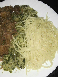 A picture of Spaghetti with fried pork and steamed cabbages.