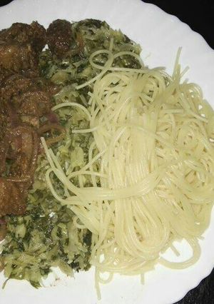 A picture of Spaghetti with fried pork and steamed cabbages.