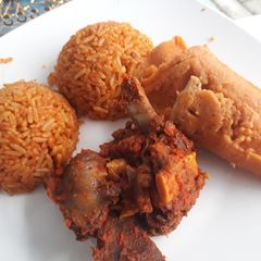 A picture of Jollof rice and moimoi.