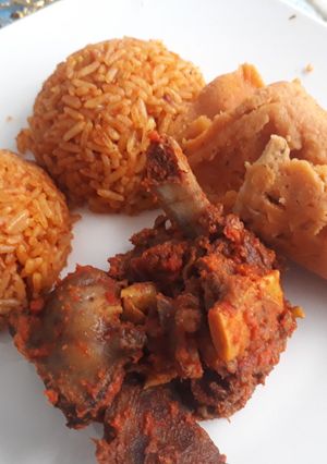 A picture of Jollof rice and moimoi.