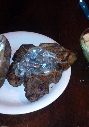 A picture of T-Bone Steak w/ Mushroom & Onion.