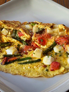 Una foto de Tortilla de espárragos, tomatitos y queso semicurado de cabra