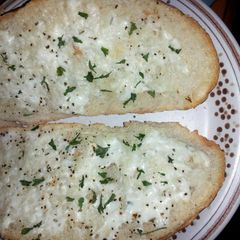 A picture of Crusty bread with ranch and sour cream spread.