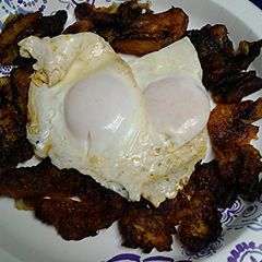 A picture of Banana and eggs breakfast.