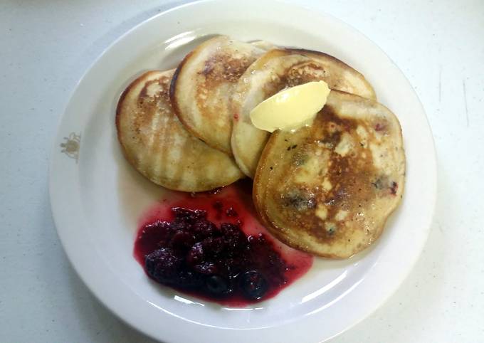 Fluffy pancakes with maple syrup butter and seasonal berries
