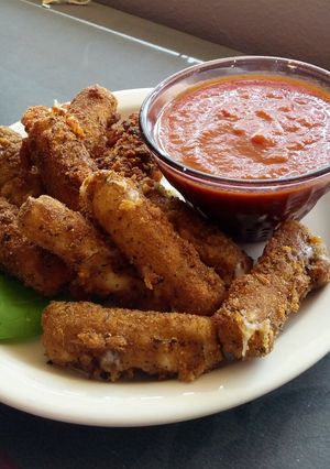 A picture of Fresh fried mozzarella sticks.