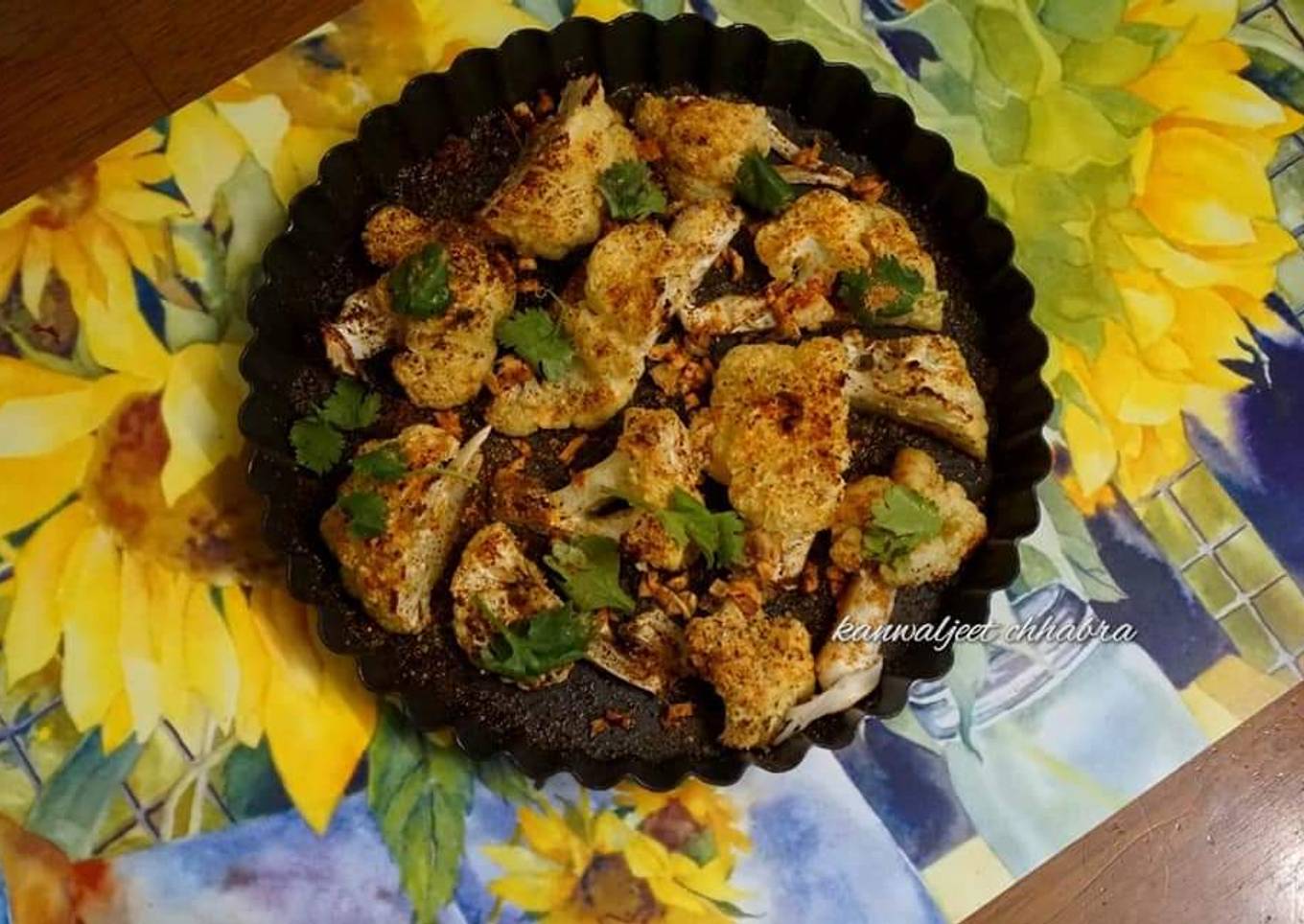 Baked cauliflower topped with parmesan cheese