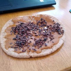 A picture of Almond Buttered Pita Bread with Cocoa Nibs.