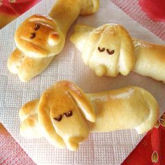 A picture of Dog-Shaped Bread Rolls: Sleeping Dachshund Wiener Sausage Bread.