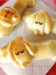 A picture of Dog-Shaped Bread Rolls: Sleeping Dachshund Wiener Sausage Bread.