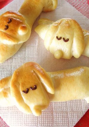 A picture of Dog-Shaped Bread Rolls: Sleeping Dachshund Wiener Sausage Bread.