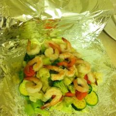 A picture of Foil wrapped veggies & shrimp.