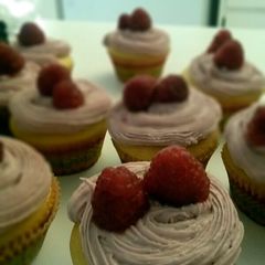 A picture of Lemon cupcakes with raspberry frosting.