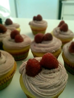 A picture of Lemon cupcakes with raspberry frosting.