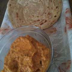 A picture of Shahi paneer and lachcha paratha.